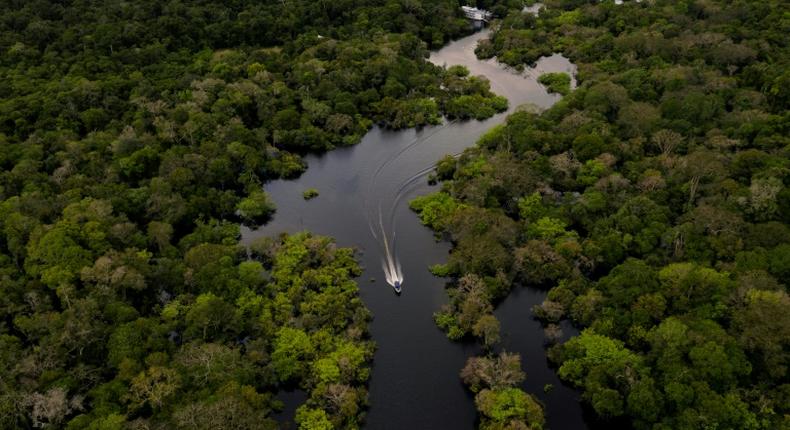 A boat travels on the Jurura river in Carauari, in the heart of the Brazilian Amazon rainforest, in March 2020 -- the entire region is facing many challenges, and now must battle the coronavirus crisis as well