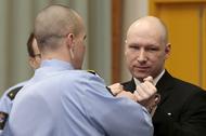 Mass killer Anders Behring Breivik has his handcuffs removed upon his arrival at the court room in S