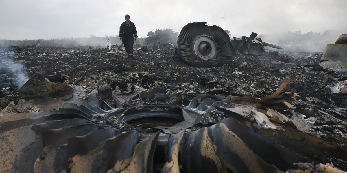 An Emergencies Ministry member walks at a site of a Malaysia Airlines Boeing 777 plane crash near the settlement of Grabovo in the Donetsk region, July 17, 2014.