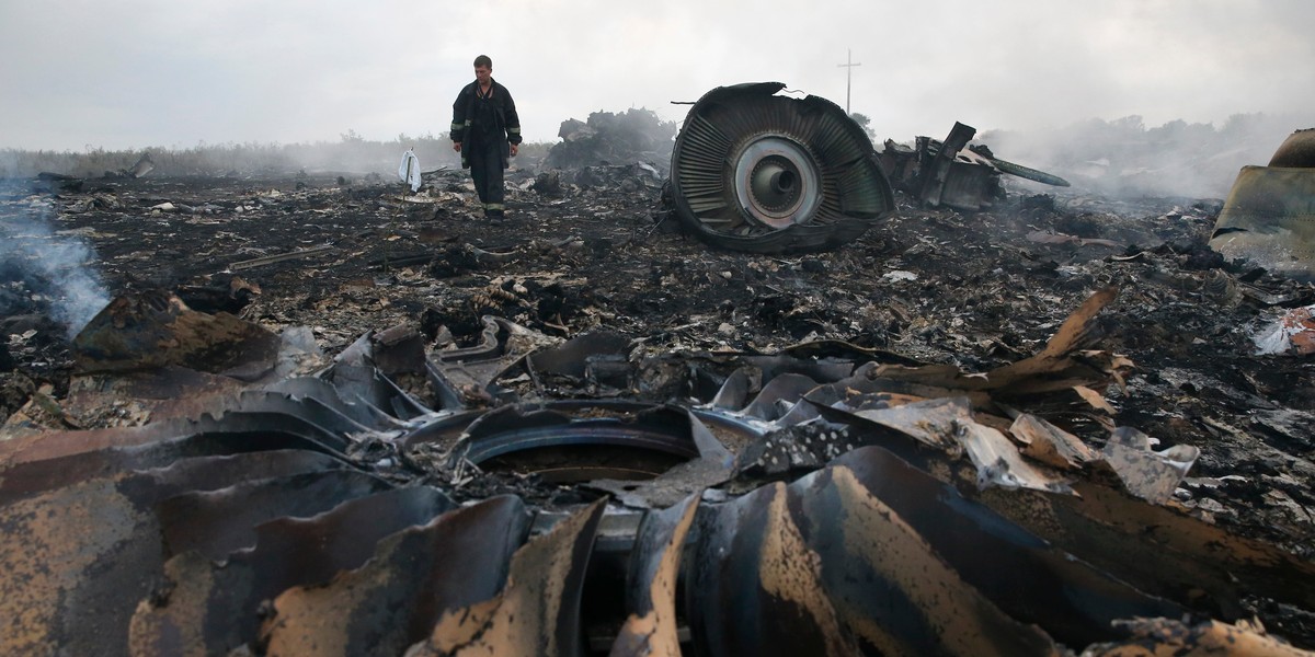 An Emergencies Ministry member walks at a site of a Malaysia Airlines Boeing 777 plane crash near the settlement of Grabovo in the Donetsk region, July 17, 2014.