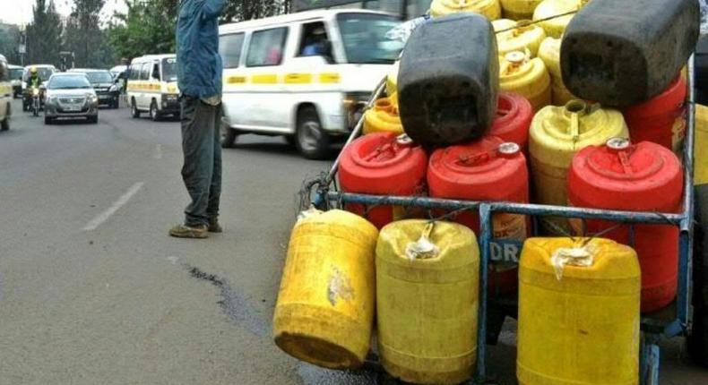 A man hawks water in jerry cans in Nairobi on August 31, 2015 