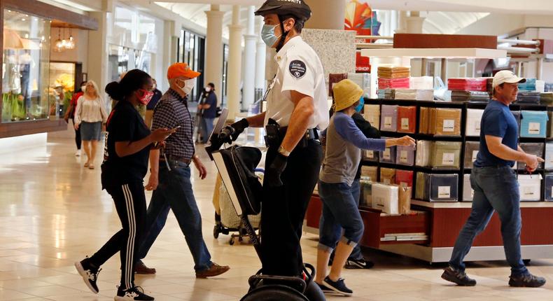 FILE - In this May 1, 2020 file photo, a security guard wearing a mask and riding a Segway patrols inside Penn Square Mall as the mall reopens in Oklahoma City.  Segway says it will end production of its namesake two-wheeled balancing personal transporter, popular with tourists and police officers but perhaps best known for its high-profile crashes. The company, founded in 1999 by inventor Dean Kamen, will retire the Segway PT on July 15.  (AP Photo/Sue Ogrocki, File