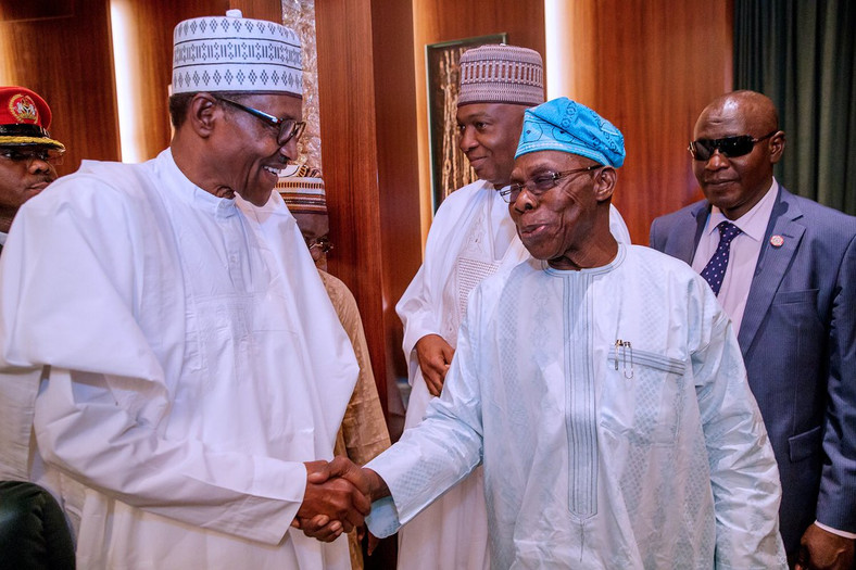 President Muhammadu Buhari shakes hands with former president, Olusegun Obasanjo [Twitter/@NGRPresident]