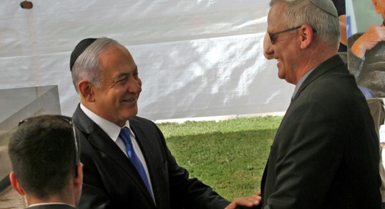 Israeli Prime Minister Benjamin Netanyahu (L) greets rival Benny Gantz, leader of Blue and White party, at a memorial ceremony for late Israeli president Shimon Peres on Thursday