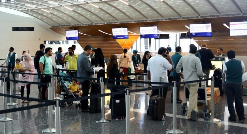 Passengers wait to check-in at the Hamad International Airport in Doha on June 7, 2017 after a ban on Qatari flights imposed by Saudi Arabia and its allies which cut ties with Doha and ordered Qataris out