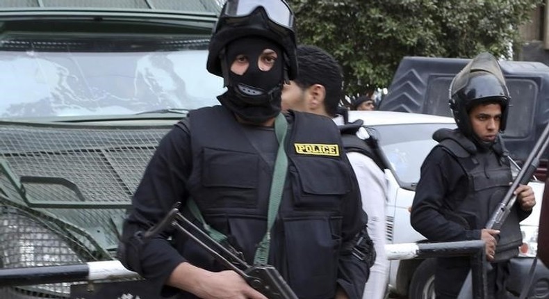 Police stand guard at a square in central Cairo January 26, 2015. REUTERS/Asmaa Waguih