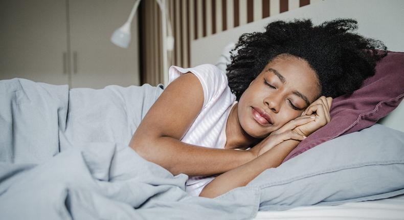 Sleeping late on the weekends to catch up after a busy week can pay off, according to scienceblackCAT/Getty Images