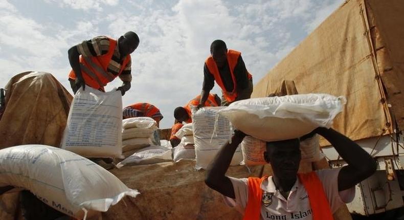 Aid workers unload food to be distributed at a camp for people displaced by the recent unrest, at the Mpoko international airport of Bangui February 12, 2014. REUTERS/Luc Gnago