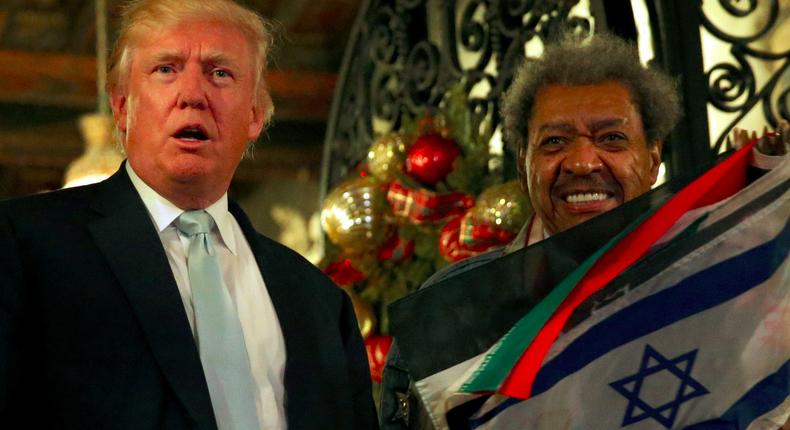 U.S. President-elect Donald Trump (L) and boxing promoter Don King speak to reporters outside the Mar-a-lago Club in Palm Beach, Florida, U.S. December 28, 2016.