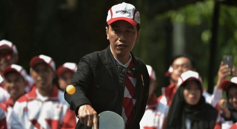 Indonesia's President Joko Widodo plays table tennis at the launch of his country's team for the 29th Southeast Asian Games taking place in Kuala Lumpur from August 19 to August 30