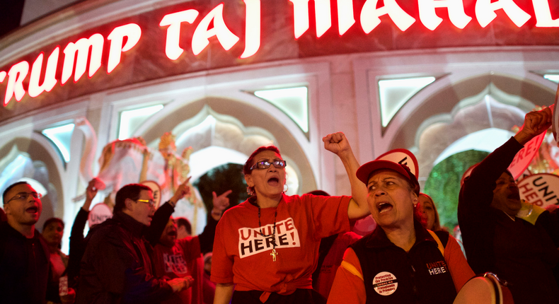 Marita Luna (C) and Miriam Ramos (2nd R) joins other union members from UNITE HERE Local 54 as they rally outside the Trump Taj Mahal Casino in Atlantic City, New Jersey October 24, 2014.