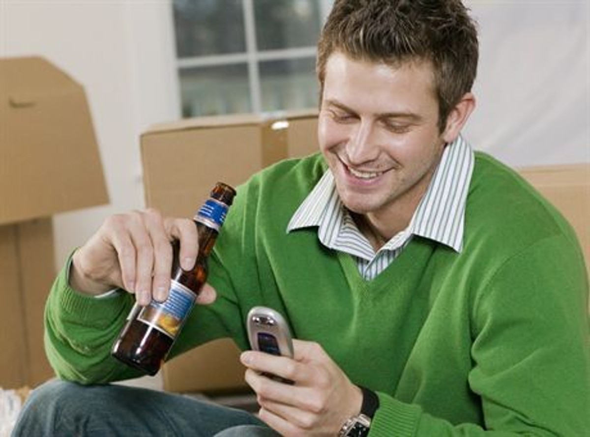 Man Taking a Break from Moving In to New Home --- Image by  Rick GomezCorbis