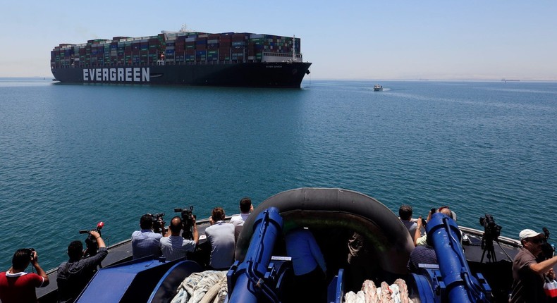 Photographers watch the Ever Given set sail in Ismailia, Egypt, July 7, 2021
