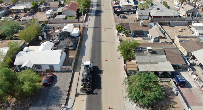 Applying cool pavement on neighborhood streets is one of the strategies Phoenix is using to mitigate the heat island effect. This water-based asphalt treatment is applied on top of existing pavement and allows the material to reflect heat unlike traditional dark asphalt which absorbs heat.City of Phoenix Street Transportation Department