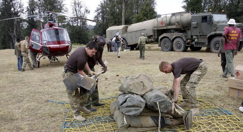 Members of the British Army pack their belongings after an operation to extinguish fire on the Chogoria side of the slopes of Mount Kenya in central Kenya, in this March 20, 2012 file photo. Kenya and Britain signed a deal on December 9, 2015 to allow British troops to continue military training in the East African nation for five more years, ending half a decade of protracted negotiations which tested their relations. REUTERS/Peter Imbote/Files