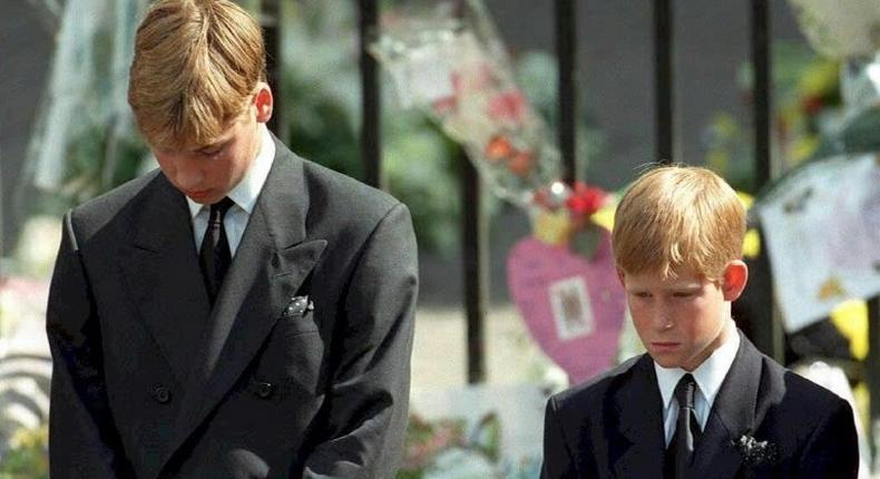 Prince William (left) and Prince Harry bow their heads during the funeral of their mother Diana, Princess of Wales, at Westminster Abbey in 1997