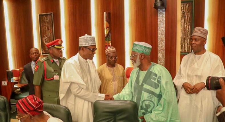 President Muhammadu Buhari shakes hands with former Head of State, Abdulsalami Abubakar, with Senate President, Bukola Saraki in the background at the National Council of State meeting that held in the Presidential Villa on January 22, 2019