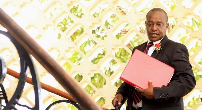 Kenya's Cabinet Secretary of National Treasury (Finance Minister) Henry Rotich carries a briefcase containing the Government Budget for the 2013/14 fiscal year inside the parliament building in Nairobi, June 13, 2013.    REUTERS/Noor Khamis