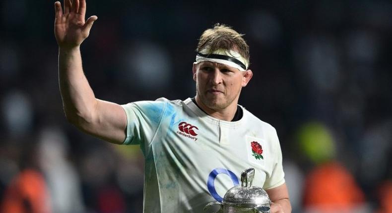 England's hooker and captain Dylan Hartley holds the Calcutta Cup trophy as leaves the pitch atfter winning the Six Nations international rugby union match between England and Scotland at Twickenham stadium in south west London on March 11, 2017