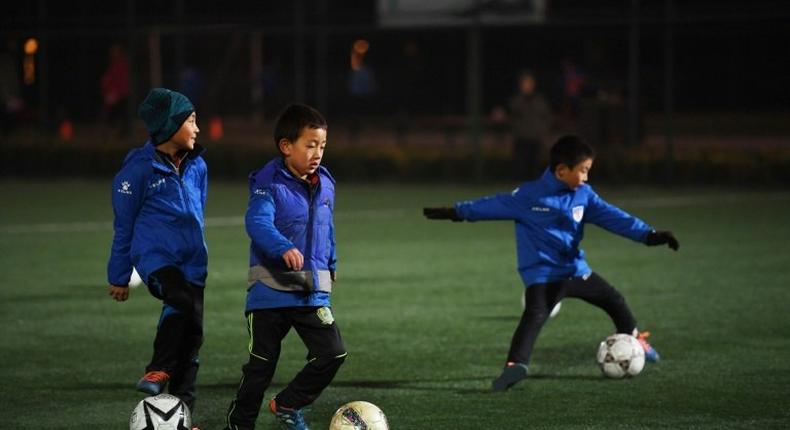 Boys attend a training session at a football club in Beijing