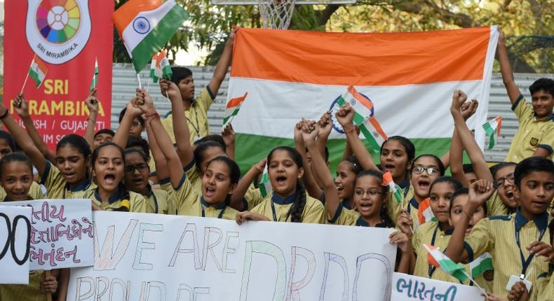 Indian students celebrate after the destruction of a low-orbiting satellite in a test of a new missile