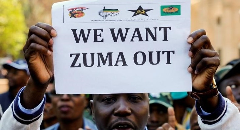 A member of a group planning to stage an ‘Occupy’ protest outside the ANC headquarters demanding South African President Jacob Zuma and other senior party officials to resign, holds a placard in downtown Johannesburg, South Africa, September 5, 2016. 