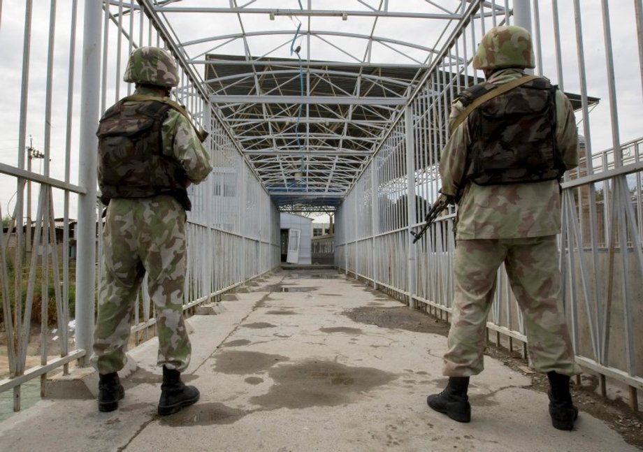 Uzbek border guards keep watch on a bridge across the Kara-Su border river between Kyrgyzstan and Uzbekistan.