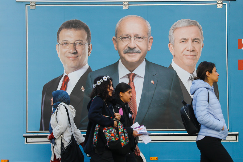 Mieszkańcy Stambułu mijają billboard wyborczy, który przedstawia kandydata na prezydenta Kemala Kilicdaroglu (w środku), burmistrza Stambułu Ekrema Imamoglu (po lewej) i burmistrza Ankary Mansura Yavasa (po prawej) 4 maja 2023 r.
