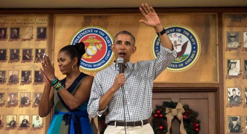 US President Barack Obama addresses troops with First Lady Michelle Obama at Marine Corps Base Hawaii in Kailua on December 25, 2016