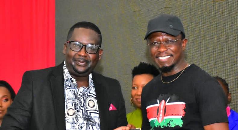 Sports and Youth Affairs Cabinet Secretary, Ababu Namwamba with comedian Daniel Churchill Ndambuki at Kasarani stadium on February 15, 2023