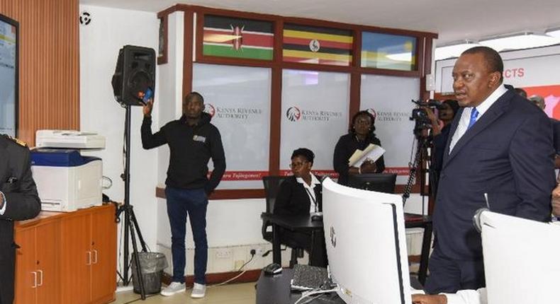 President Uhuru Kenyatta with workers at a KRA centre during a past visit