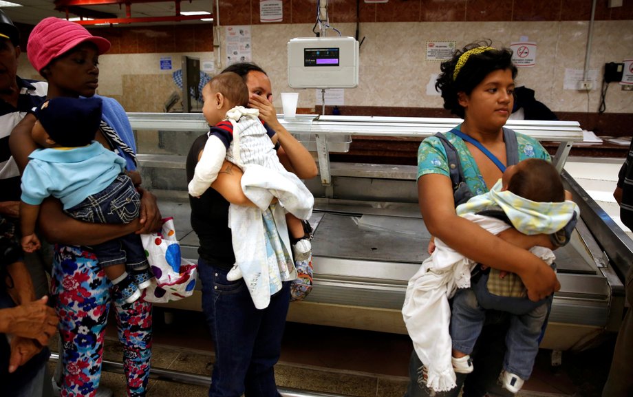 People line up to buy food and other staple goods inside a supermarket in Caracas, Venezuela, June 30, 2016.