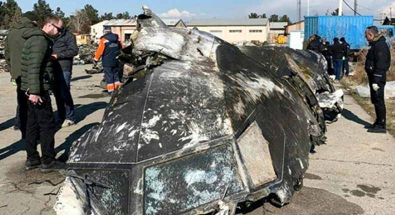 People analyze the fragments and remains of the Ukraine International Airlines plane that crashed outside Tehran