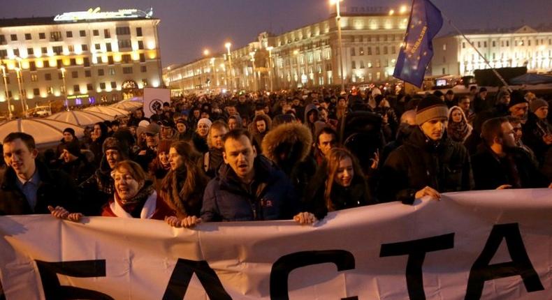 People carry a banner reading Stop during a rally called the March of Infuriated Belarusians against a Soviet-style tax on spongers in Minsk, on February 17, 2017, with biggest round of opposition protests yet planned for March 25, 2017