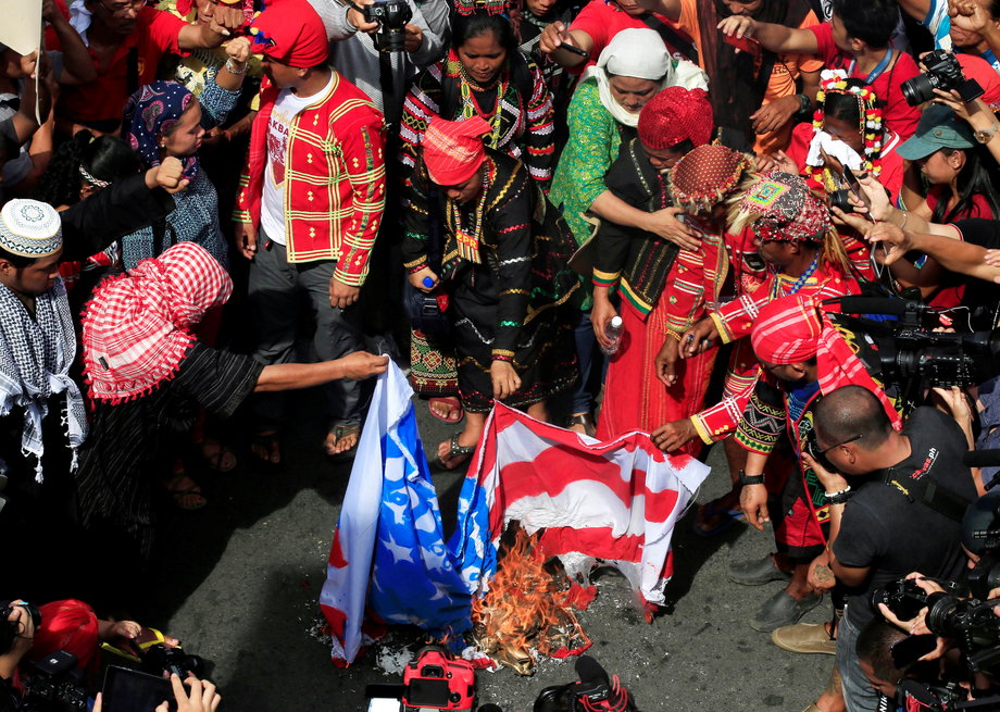 Various activist and Indigenous people's groups burn a mock US flag during a rally supporting President Rodrigo Duterte's independent foreign policy, in metro Manila, Philippines, October 21, 2016.