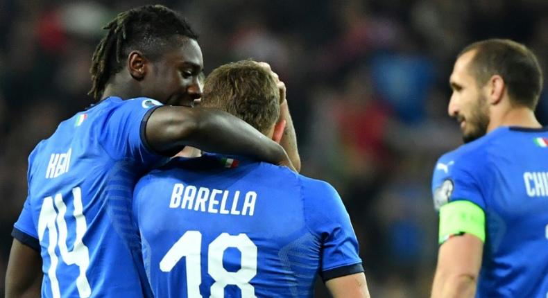 Italy's midfielder Nicolo Barella (C) and Moise Kean (L) scored in either half against Finland