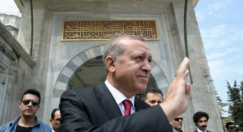 Turkish President Recep Tayyip Erdogan (C) greeting his supporters during a visit to the Ottoman Fatih Sultan Mehmet's tomb in Istanbul, a day after his victory in a national referendum on April 17, 2017