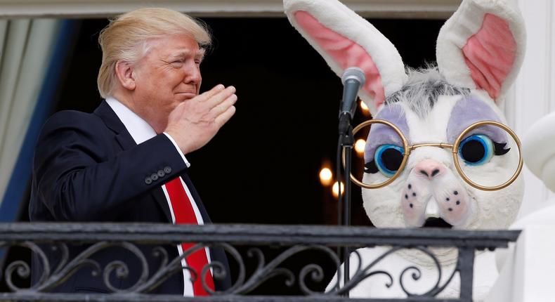 President Trump salutes a member of the military (not seen in photo) who had just sung the U.S. national anthem as he stands with a performer in an Easter Bunny costume at the White House Easter Egg Roll.