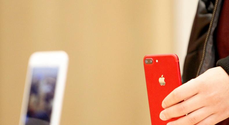 FILE PHOTO: A person holds a red iPhone product at a Apple store in Nanjing, Jiangsu province, China, March 25, 2017.   REUTERS/Stringer