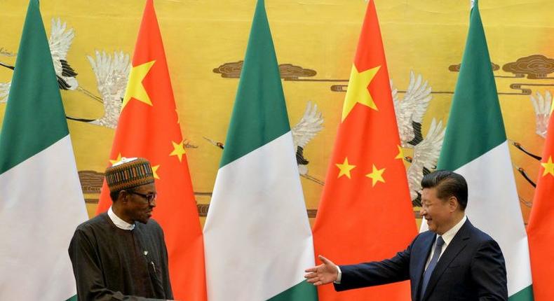 President of the Federal Republic of Nigeria, Muhammadu Buhari (L) and Chinese President, Xi Jinping shake hands during a signing ceremony at the Great Hall of the People in Beijing, April 12, 2016. REUTERS/Kenzaburo Fukuhara/Pool