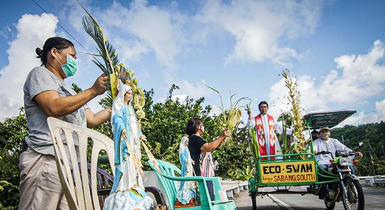 Roman Catholic priest Pepe Quitorio delivers blessing from a motorised tricycle in Borongan in the central Philippines