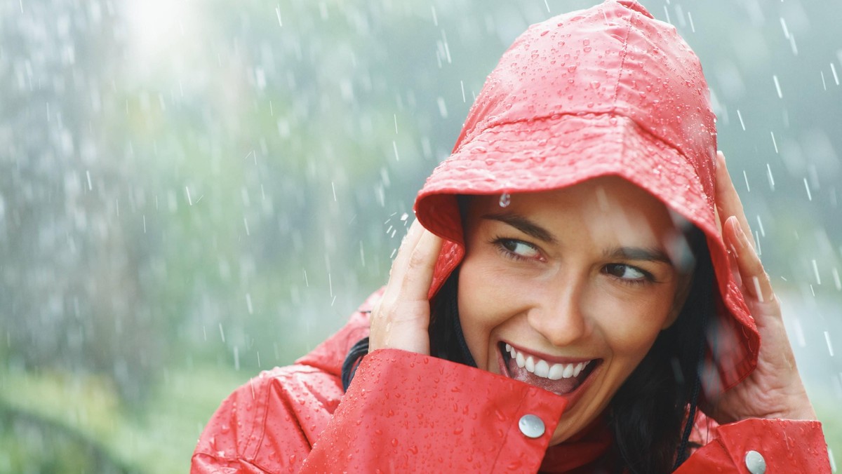 Woman smiling while out in rain