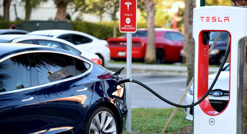 A Tesla Model 3 charges at a Supercharger.Paul Hennessy/NurPhoto via Getty Images