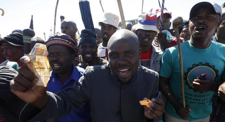 Striking platinum miners sing and dance during a rally near Lonmin's Marikana mine April 29, 2014. REUTERS/Mike Hutchings