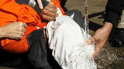 File photo of demonstrators simulating waterboarding at the Justice Department in Washington