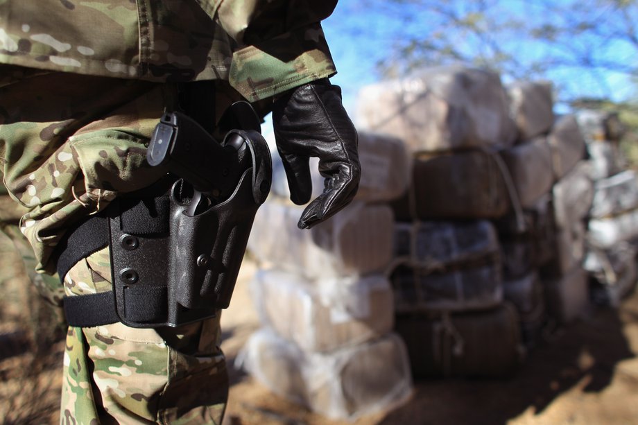 US Special Agent Rodney Irby looks over some 500 pounds of marijuana seized on January 18, 2011, in the Tohono O'odham Nation, Arizona.