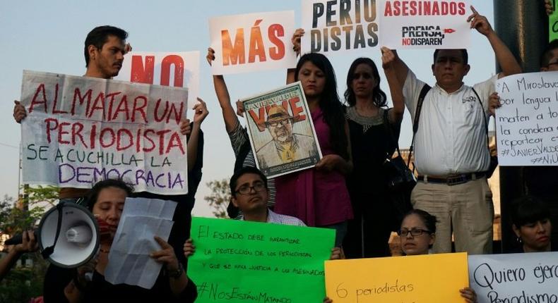 Journalists hold signs condemning violence against journalists while protesting the recent murder of the of Mexican journalist Javier Valdez on May 16, 2017 in Guadalajara