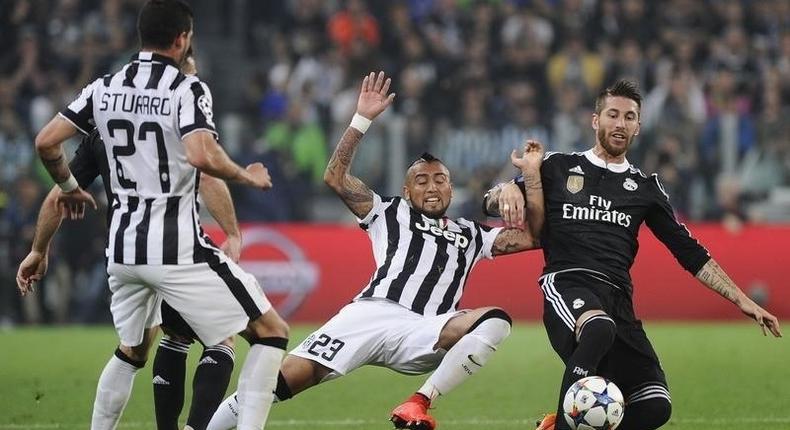 Real Madrid's Sergio Ramos in action with Juventus' Arturo Vidal. Reuters / Giorgio Perottino