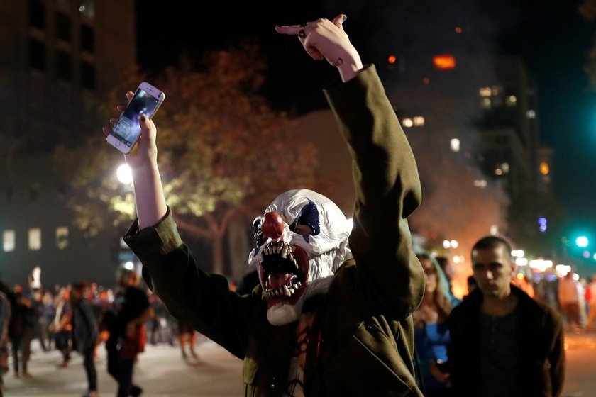 Mężczyzna protestuje  w masce na ulicach Oakland