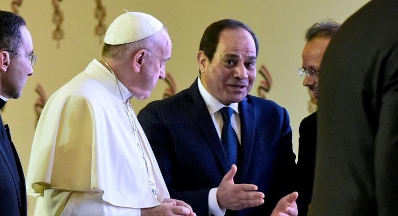 Pope Francis and Egyptian President Abdel Fattah al-Sisi chat with officials after meeting in Cairo on April 28, 2017